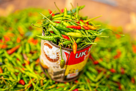 small red and green chili pepper in tin can at a local organic market