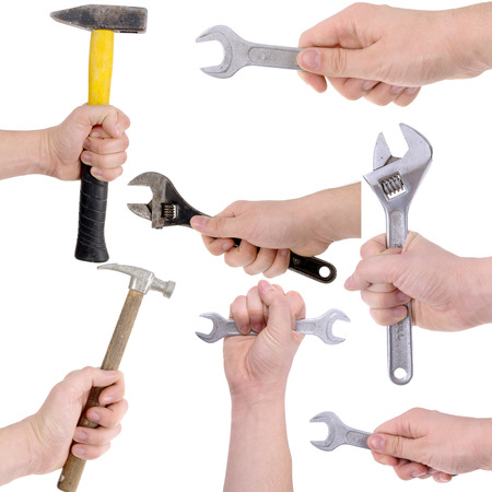 Many hands holding different tools for working and fixing thingsの写真素材