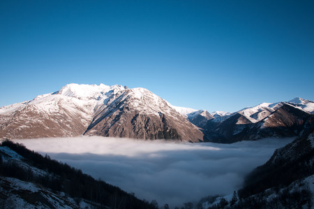 Panoramic view on the alps at sunrise with fog in the valleyの写真素材
