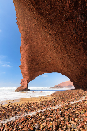 Red arches and rocky beach at the Atlantic Ocean in the region Sous-Massa-Draa, Legzira, Morocco, Africaの写真素材