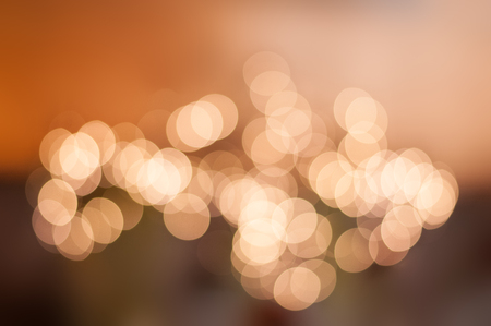 Defocused pastel lights bokeh and an warm orange blurred backgroundの写真素材