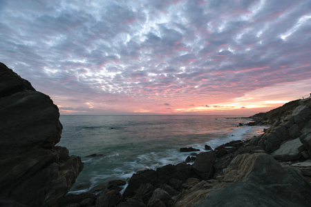 A landscape of the Costa de la Luz at sunset with a very dramatic sky and awesome clouds and a beautiful orange and red light. Photo taken near Tarifa, Spain.の写真素材