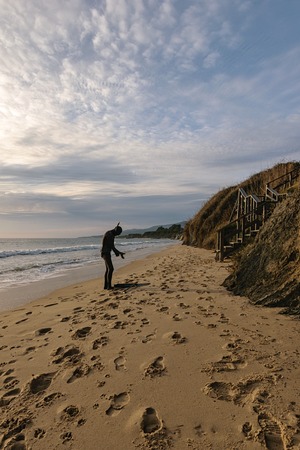 A snorkeler with a harpoon at the beach getting ready to go for a dive.の写真素材