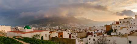 Awesome view over Tetouan at sunset. You can also see the mountains covered in clouds in the background.の写真素材