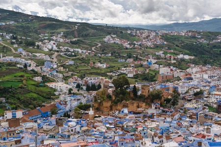 Awesome view over the blue painted city Chefchaouen in Morocco. In the middle you can see the historical Kashbah.の写真素材
