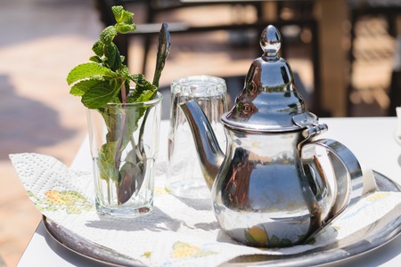 Teapot and glass with mint leaves, Moroccoの写真素材