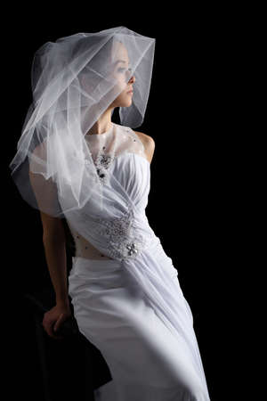 the wedding fashion bride sitting on the stool on the black back groundの写真素材