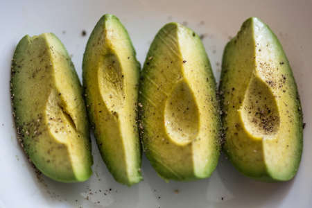 the avocado on the plate - a great source of healthy fat, makes you fitの写真素材