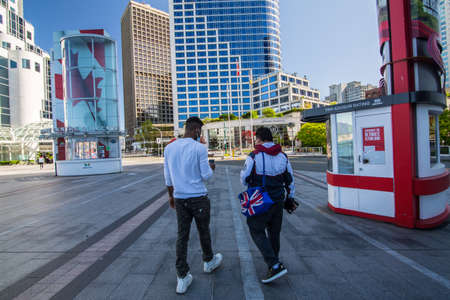 Vancouver, BC, Canada, May 8th, two men walking in medical masks in the empty Canada Place terminal, no cruise ships, no business, clean and quiet due to COVID19 quarantine 2020のeditorial素材