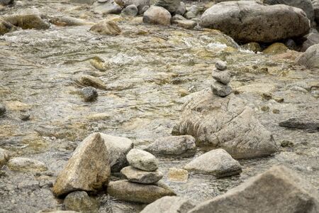 Stones stacked on top of each other in the river.の写真素材