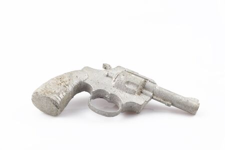 Casting of old metal hand firearm. Colt of tin separated on white background.の写真素材