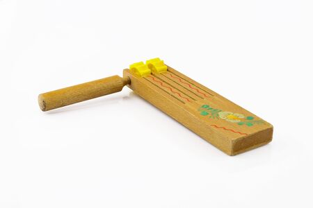 Traditional Slovak folk wooden product with floral motif, symbol of Easter. Ratchet separated on white background.の写真素材