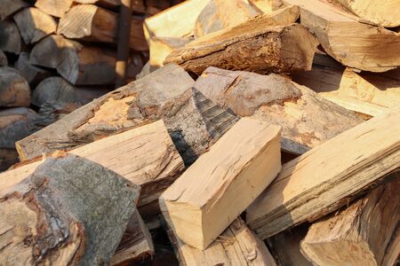 Sawing wood and preparing firewood for winter. Stacked pieces of wood on top of each other.の写真素材