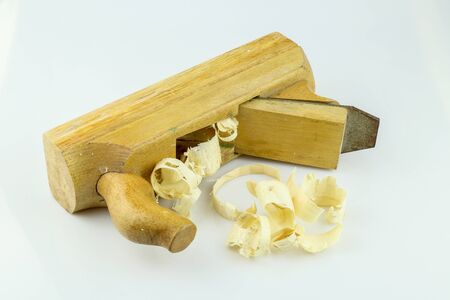 Traditional wooden jack-plane with wood sawdust isolated on white background. Old hand jack plane and wood chips.の写真素材