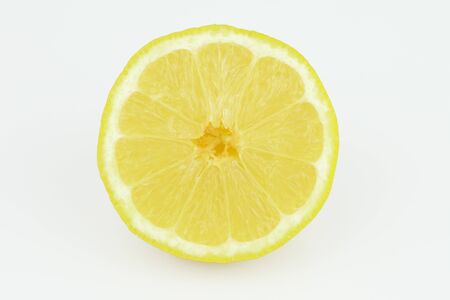 Half of ripe fresh lemon isolated on white background. Yellow fresh sliced lemon separated on white backgroundの写真素材