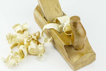 Detail of traditional wooden jack-plane with wood sawdust isolated on white background. Old hand jack plane and wood chips.の写真素材