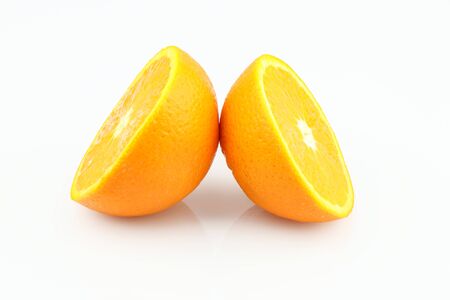 Fresh orange halves isolated on white background. Fresh sliced orange separated on white backgroundの写真素材