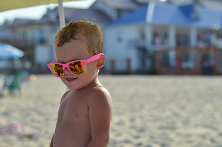 Child wearing pink sunglassesの写真素材