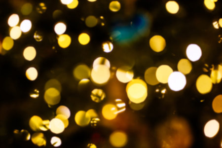 Golden bokeh lights forming a blurred abstract background, offering a festive and celebratory...