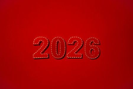 Red numbers 2026 with white stitching details standing against a vibrant red background, signifying the arrival of the New year, anticipated future, and upcoming datesの写真素材