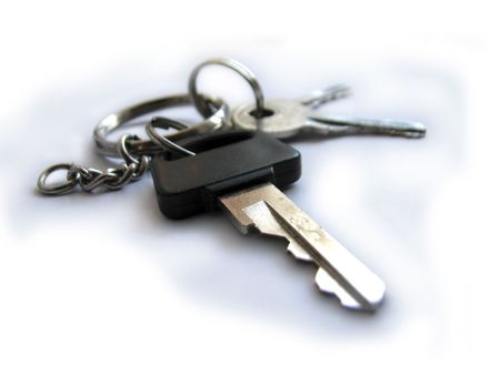 The bunch of keys lies on a white backgroundの写真素材