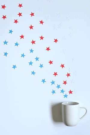 beautiful white mug with handle with stars in the colors of the American flag, on white background with copy spaceの写真素材