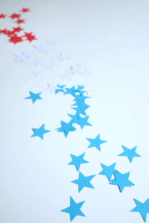White background with stars the color of the usa flag, red, blue, white with copy spaceの写真素材