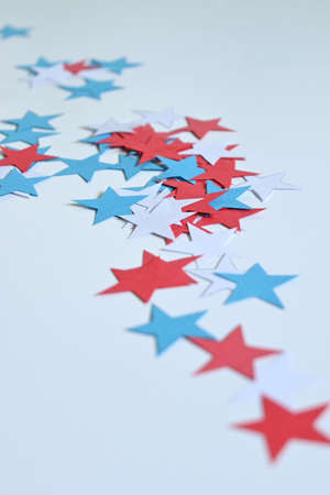 White background with a set of five-pointed stars in the colors of the usa flag, red, white and blueの写真素材