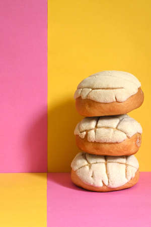 creative colorful photo closeup of traditional Mexican vanilla shells on a pink and yellow plaid backgroundの写真素材
