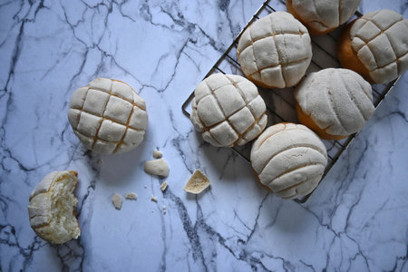 overhead close-up of delicious traditional Mexican vanilla shells on white and gray marble rack and...