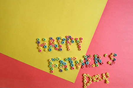 "happy father's day" poster made with colored cereals on orange and yellow backgroundの写真素材