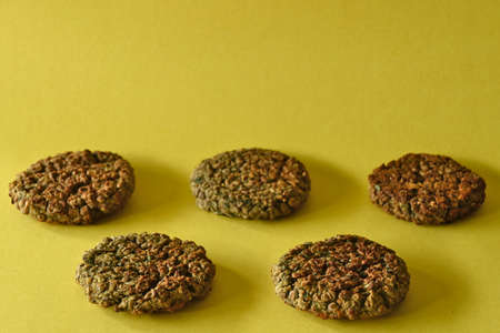 Close-up of lentil burgers, yellow background, with copy spaceの写真素材