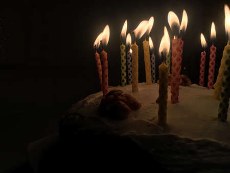 Birthday cake with lighted candlesの写真素材