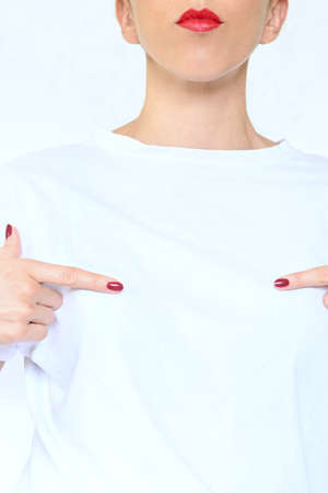 Woman pointing with her hands to white copy space, white backgroundの写真素材