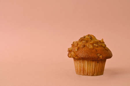 traditional pecan cupcake on pastel pink background with copy spaceの写真素材