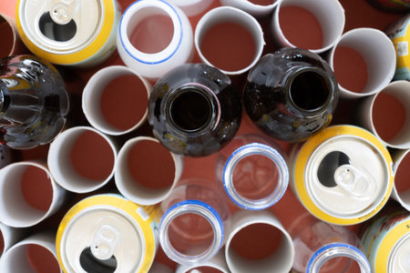 Mixing of glass bottles, cardboard, plastic and cans, recycling concept, select focus