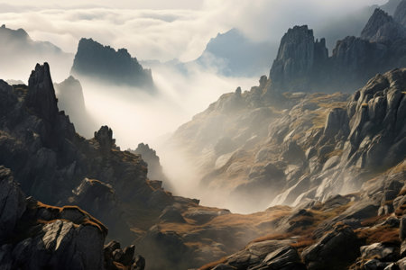 Ethereal view of a mist-covered mountainous terrain basked in soft morning sunshineの素材