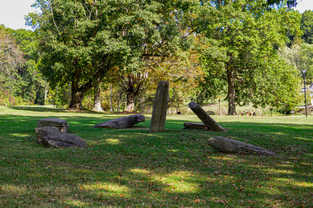 Old stone bench in the park at sunny summer day.の写真素材