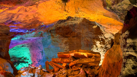 Illuminated Cave Interior with Multicolor Lights on Rock Formationsの写真素材