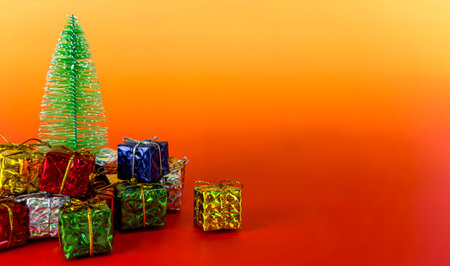 Christmas tree and gift boxes on orange background. Christmas and New Year concept.