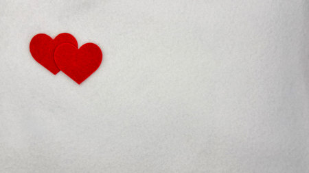 Two Red Felt Hearts On White Background With Copy Space