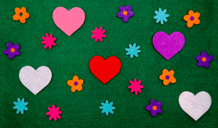 Colorful Felt Hearts And Flowers On Green Backgroundの写真素材