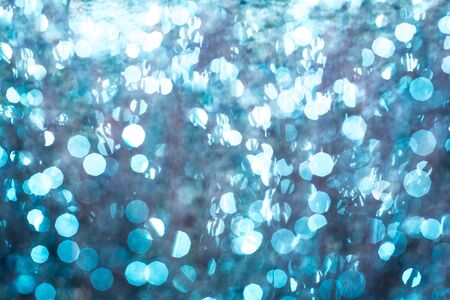 Bokeh Background.Christmas blue lights.abstract ,winter white glitter,diamonds shine,blur background with defocusの写真素材