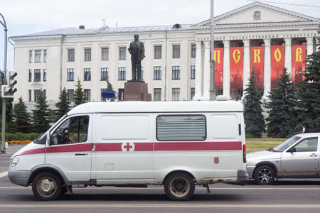 Pskov Russia 06.07.2020 Ambulance on the background of the monument to Lenin and Pskov state Universityの写真素材