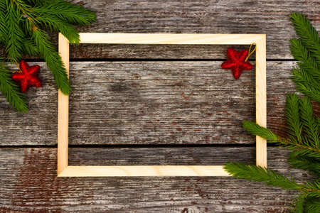 Christmas background for greeting card. wooden frame and Fir branches on wooden background.の写真素材