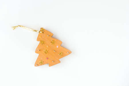 Christmas toy in the form of a wooden Christmas tree lying on the tableの写真素材