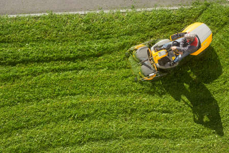Russia Peterhof 14.09.2020.man in a work uniform mows lawn with a Garden Riderのeditorial素材