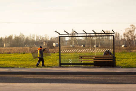 workers equip a new public transport stop in a new residential areaの写真素材