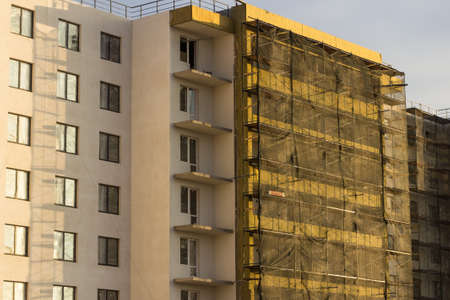 building under construction in scaffoldingの写真素材