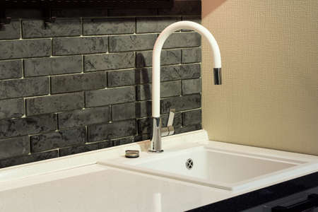 white granite sink with mixer tap in the kitchenの写真素材